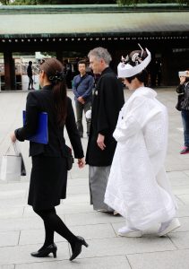 A couple in their wedding attire at Meiji Shrine, Tokyo