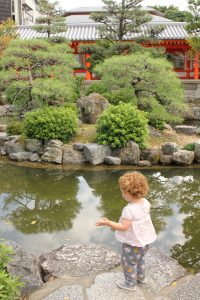 Toddler near pond in temple, Kyoto, Japan