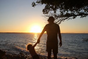Father and daughter at sunset, Noosa, Australia