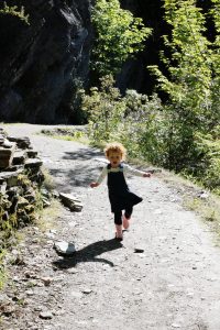 Toddler running down hill, Arrowtown, New Zealand