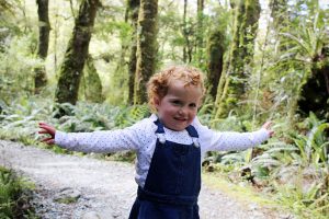 Toddler running along the trail. Marian Falls Trek, Fiordland, New Zealand