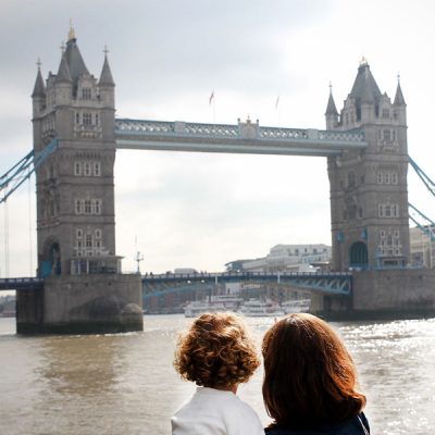Mum and daughter looking at Tower Bridge, London